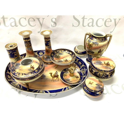 1049 - A Noritake porcelain dressing table set with camel and desert scene. (D)