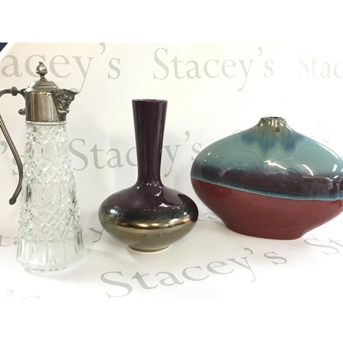 1055 - A collection of vases including art vases and a Falstaff cut glass vase with a silver plated top. Th... 