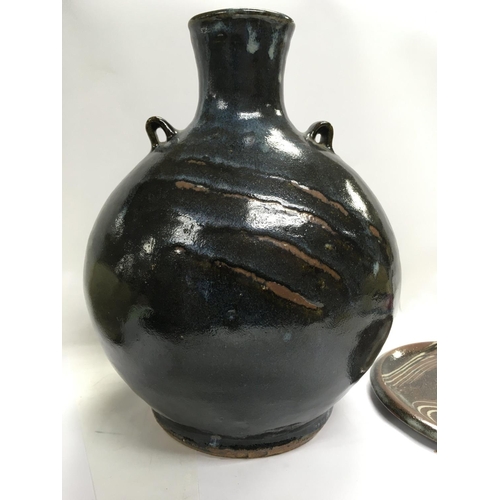 1083 - A collection of stone ware art pottery comprising twin handle blue and black glazz vase 30 cm Two st... 