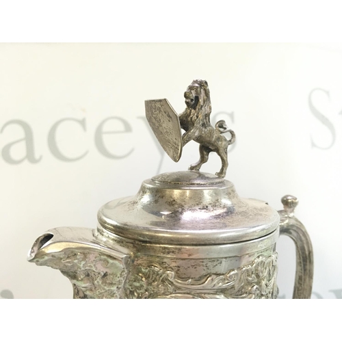 1112 - A cut glass jug with a lion and shield figure topper , 32cm tall. No obvious large damage or restora... 