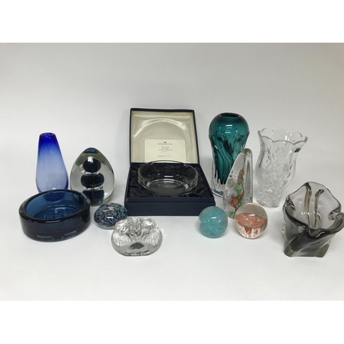 1120 - A mixed collection of glassware including paperweights bowls and vases as well as a limited edition ... 