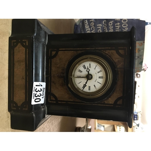 1202 - A black wooden mantle clock, the circular dial having Roman Numerals NO RESREVE