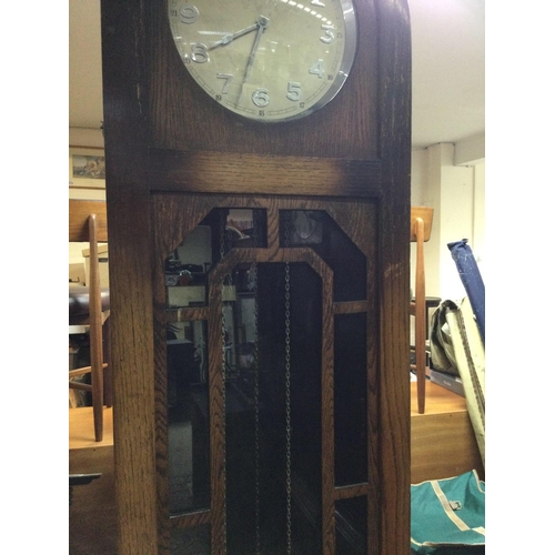 1221 - A oak three train longcase clock the circular dial with Arabic numerals. NO RESERVE