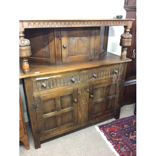 1228 - An oak 18th century style court cupboard with bulbous supports drawers and cupboards. 130x48cm. NO R... 