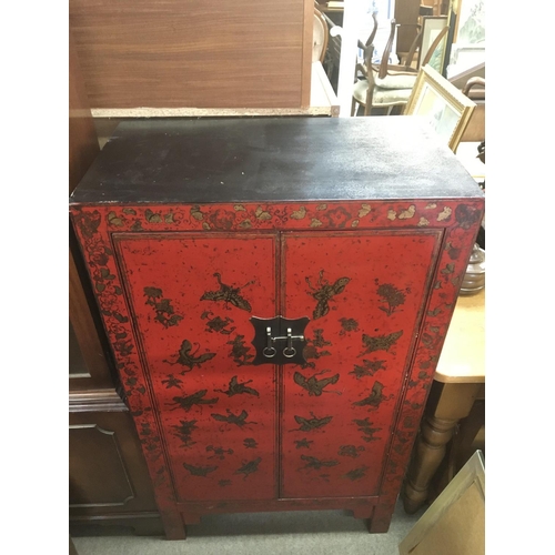 1267 - A 20th century Vietnamese red lacquer cabinet with butterfly and floral design, dimensions 42x70x120... 