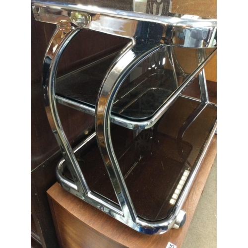 1276 - A three tier chrome trolley inset with glass tops on casters . 83cm x 44 cm . NO RESERVE