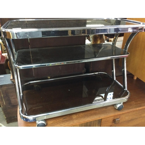 1276 - A three tier chrome trolley inset with glass tops on casters . 83cm x 44 cm . NO RESERVE