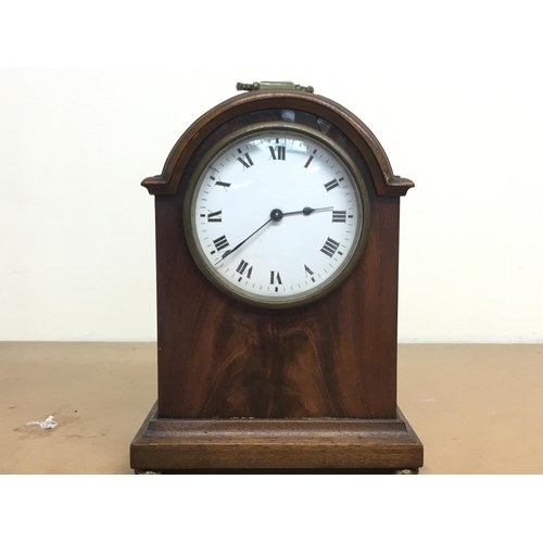 1277 - A small mahogany Edwardian mantle clock with brass handle and enamel dial, this lot cannot be posted