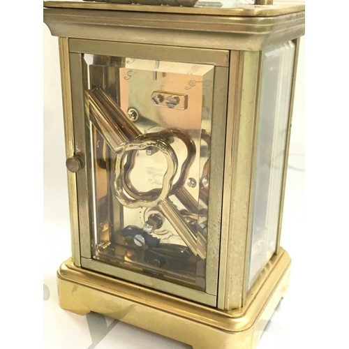 1295 - A brass Garrard & Co carriage clock, dimensions 6x8x12cm approximately. With key , seen working. thi... 