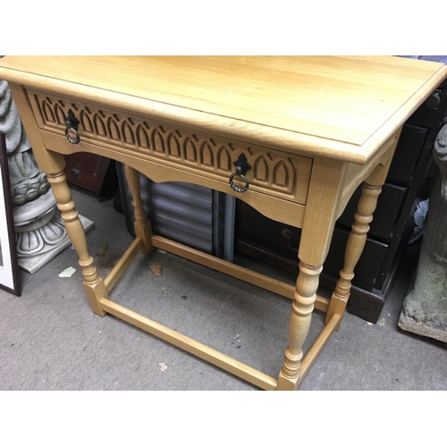 1296 - A light oak side table with single drawer on turned legs united with under stretch.