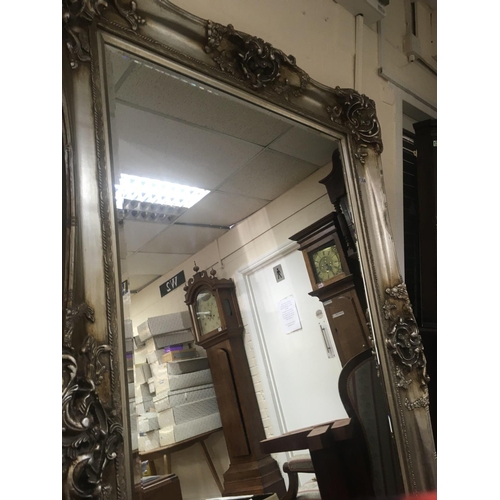 1304 - A large silver framed mirror with bevelled edge plate . 118 x184 cm .