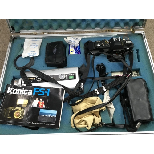 2057 - A cased Konica FS-1 camera with various accessories including a Yashica Electro 8 LD-6. Postage cate... 