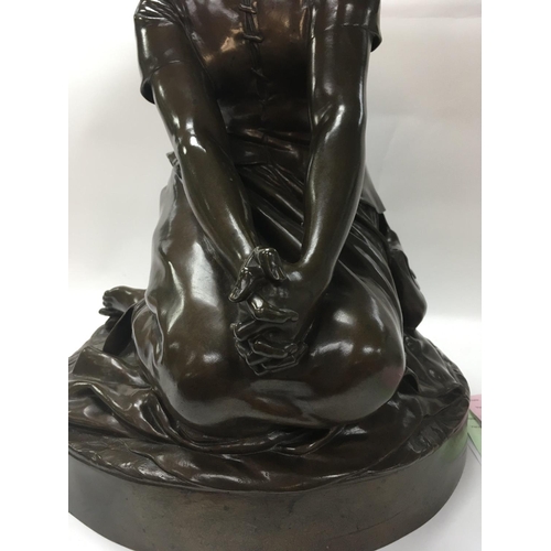 700 - A bronze figure in the form of a maiden kneeling with clasped hands .signed Chapu . 46 cm