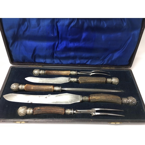 702 - A stag horn cased carving set.Postage B