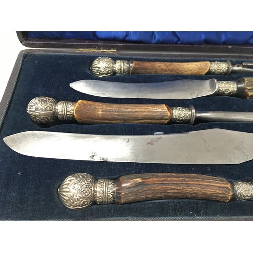 702 - A stag horn cased carving set.Postage B