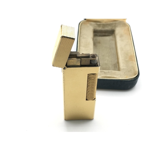 704 - A vintage Dunhill gold tone lighter with case and paperwork.Postage B