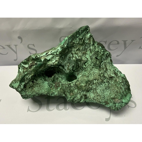 717 - A large natural Zambian Malachite specimen in the form of a Dragons head, 28cm x 21cm, 4.74kg.