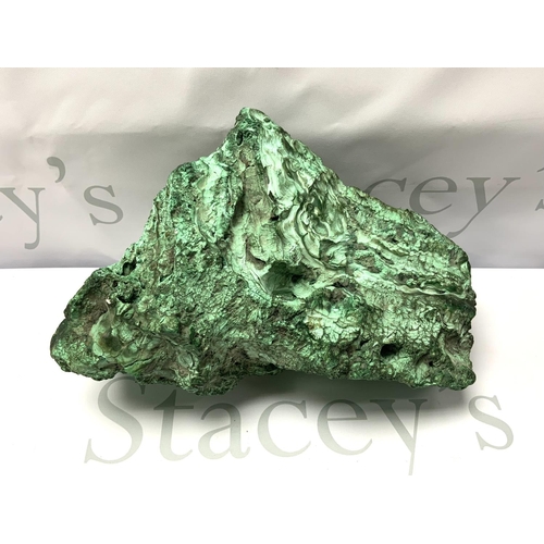 717 - A large natural Zambian Malachite specimen in the form of a Dragons head, 28cm x 21cm, 4.74kg.