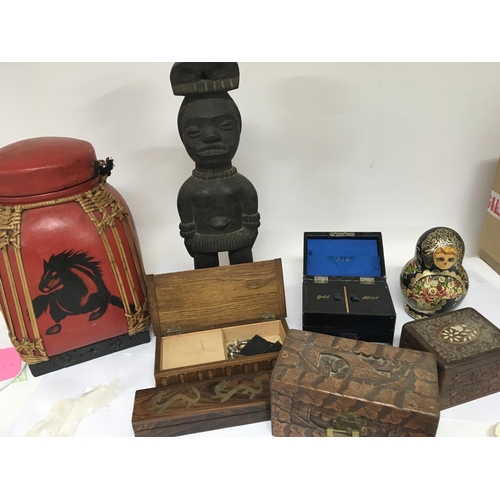 718 - A carved hardwood tribal figure carved wood boxes a leather jewellery box and Russian doll and other... 