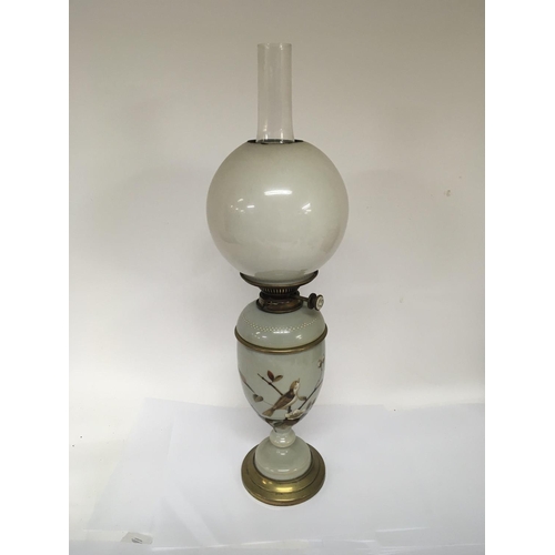 719 - A Victorian opaque glass and enamel decorated oil lamp with an opaque shade and glass chimney. NO RE... 