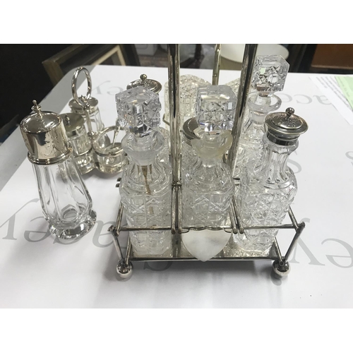 726 - A six bottle cruet frame and two smaller ones along with a silver topped sugar caster. Postage D. NO... 