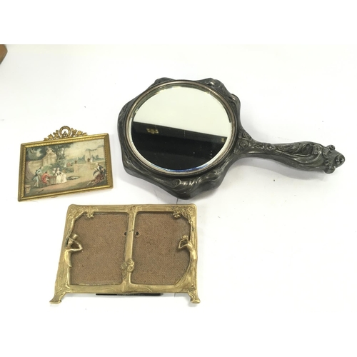 730 - An art nouveau embossed pewter hand mirror, art nouveau small gilt framed double picture frame and a... 