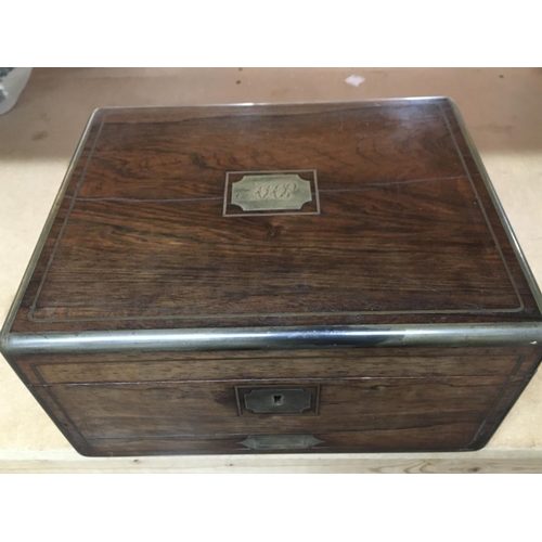 736 - A George IV Rosewood and brass bound travelling toilet box with fitted interior including glass jars... 