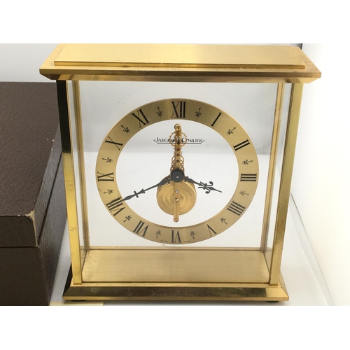 738 - A Jaeger LeCoultre mantle clock with own fitted box. Winds and runs. 16cm wide and 17cm tall. Postag... 