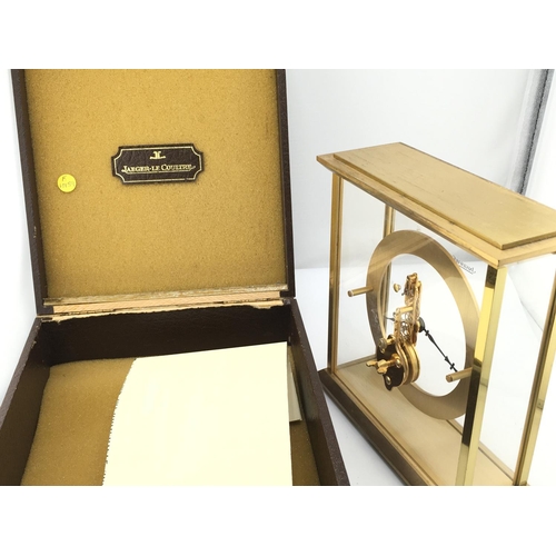 738 - A Jaeger LeCoultre mantle clock with own fitted box. Winds and runs. 16cm wide and 17cm tall. Postag... 