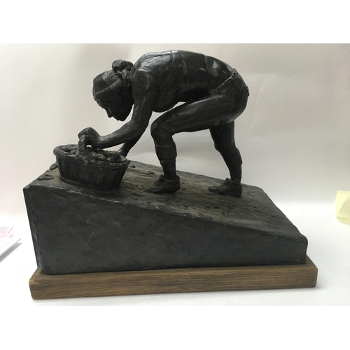 749 - A bronze figure the Harvest sculptor by Archie Forrest on an oak plinth base . 28 cm .