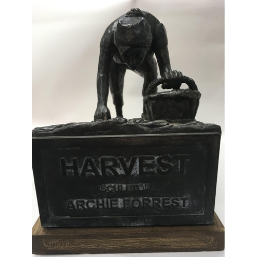 749 - A bronze figure the Harvest sculptor by Archie Forrest on an oak plinth base . 28 cm .