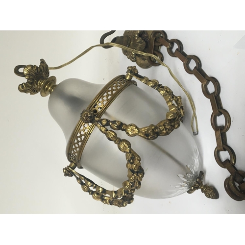 755 - A brass and glass hall lantern with raised brass garlands.no obvious damage with chain and ceiling r... 