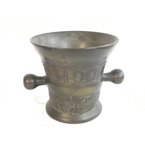 774 - An antique bell shaped bronze mortar , with inscription 1640 Andom. 10cm tall. Postage category B