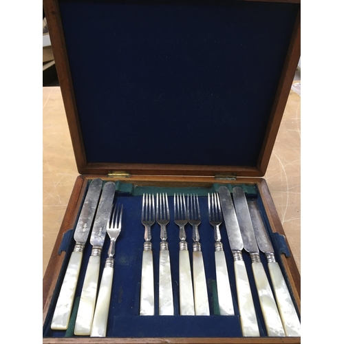 776 - A wooden cased set of mother of pearl cutlery