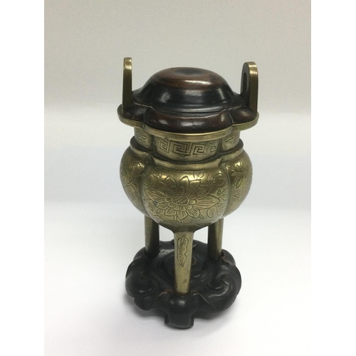 808 - A bronzed censor with a carved hardwood lid and stand, total height approx 14cm. Shipping category B... 