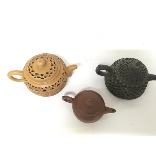 825 - Three Chinese Yixing teapots. 5 to 9cm tall approximately. Restoration seen on smallest teapot This ... 