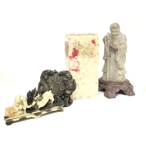 835 - A collection of soapstone including a Sage figure (20.5cm tall), a seal (17.5cm tall), a soapstone d... 