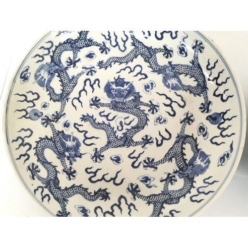 843 - 19/20th Century Chinese blue and white dragon plates, both with six character marks on the base. 26.... 