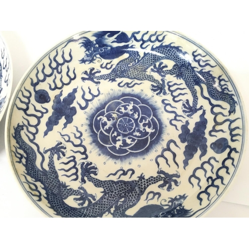 843 - 19/20th Century Chinese blue and white dragon plates, both with six character marks on the base. 26.... 