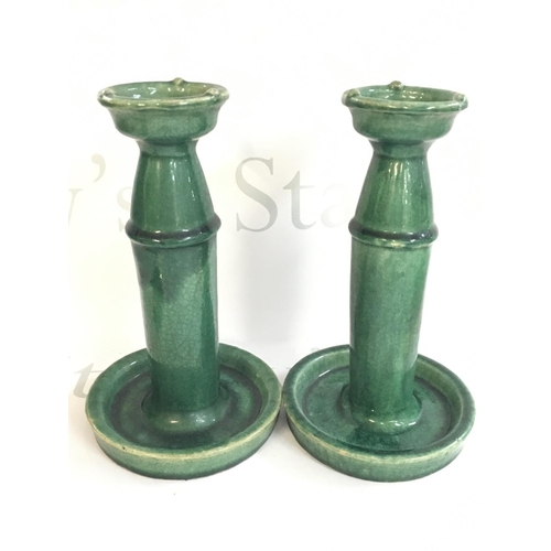 855 - A pair of Chinese green glazed oil lamps, 24cm tall. This lot cannot be posted