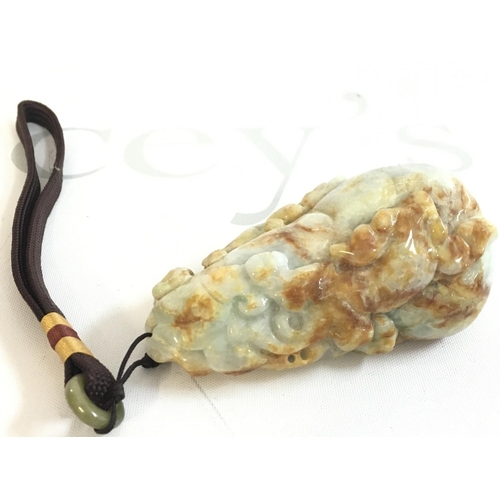 856 - A Chinese carved Jade pebble , 9cm long this lot cannot be posted