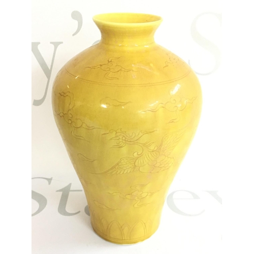 868 - A Chinese yellow glazed vase decorated with Phoenix, 17.5cm tall. Six figure mark on base. No obviou... 