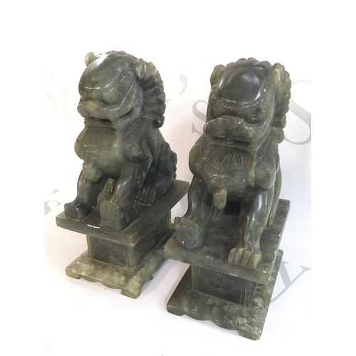 879 - A pair of Chinese jade lion dogs , 19cm tall. This lot cannot be posted