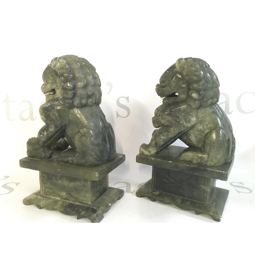 879 - A pair of Chinese jade lion dogs , 19cm tall. This lot cannot be posted