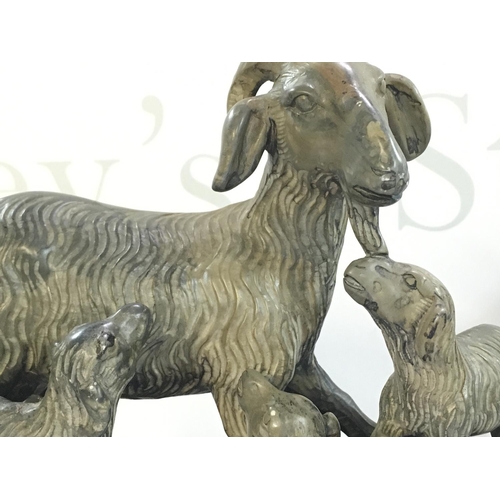 881 - A Chinese soapstone goat figure with a wooden base , 18cm tall. This lot cannot be posted