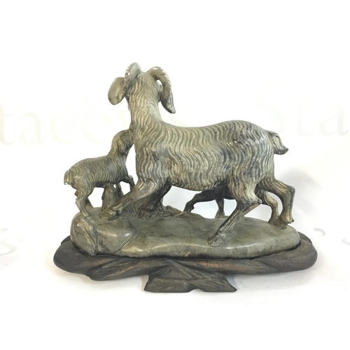 881 - A Chinese soapstone goat figure with a wooden base , 18cm tall. This lot cannot be posted