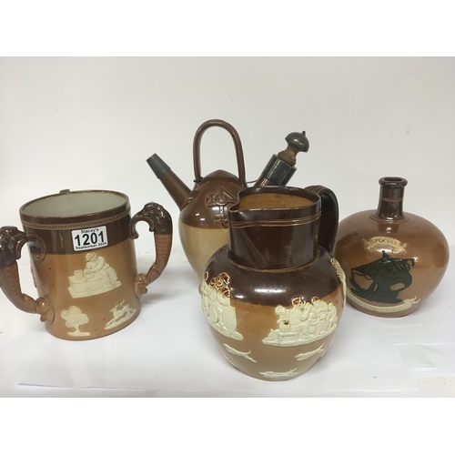 915 - A group of Lambeth and Royal Doulton stoneware ceramics. Including a silver mounted puzzle jug no ob... 