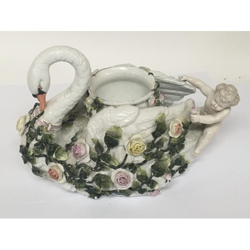 932 - A German late 19th century porcelain jardiniere ornament in the form of a swan encrusted with raised... 