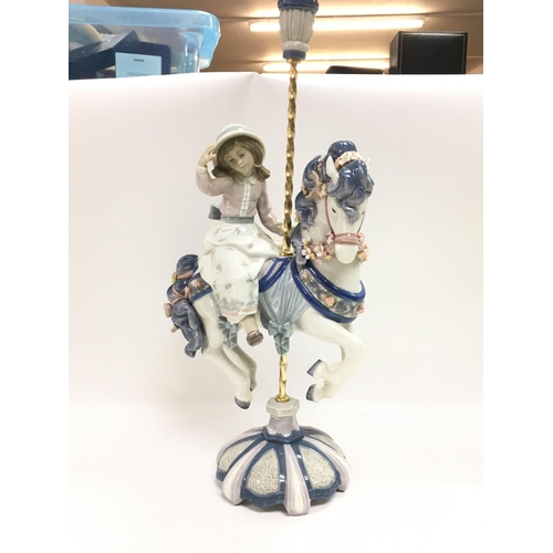 975 - A Lladro girl on a carousel horse porcelain figure. Some flowers missing however no obvious large da... 