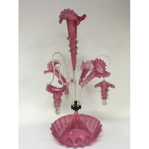 993 - An exceptional Victorian opaque and cranberry glass epergne with hanging baskets and three trumpet f... 